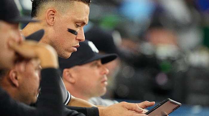 Yankees right fielder Aaron Judge reviews a play on a tablet.